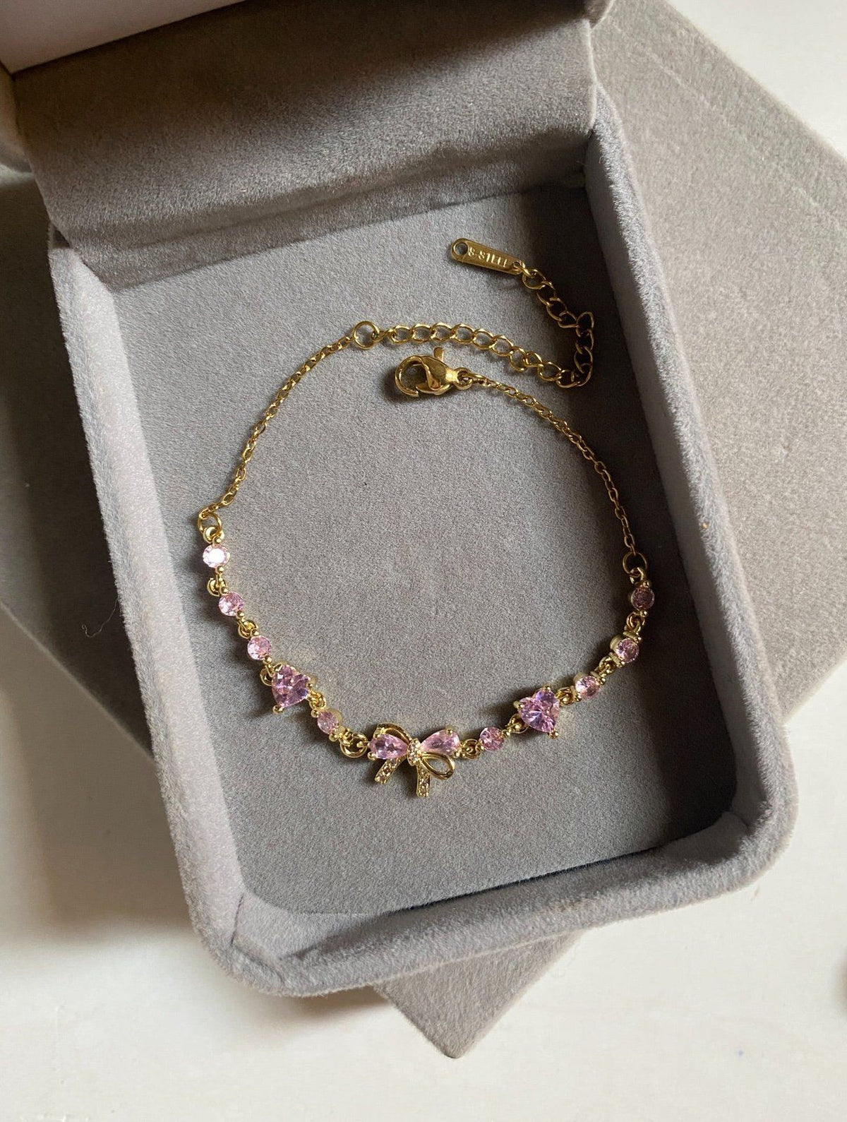 Gold Bow Bracelet flat lay showing the adjustable chain and lobster clasp