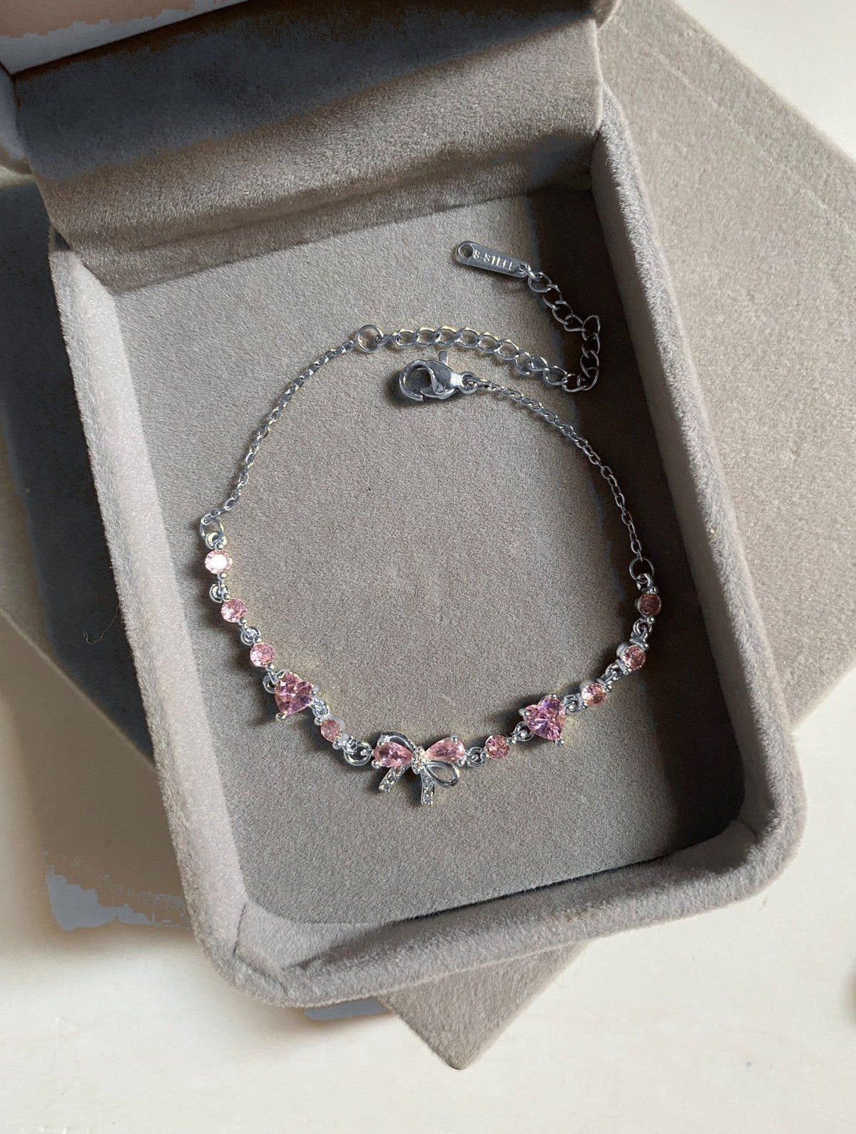 Silver Bow Bracelet flat lay showing the adjustable chain and lobster clasp