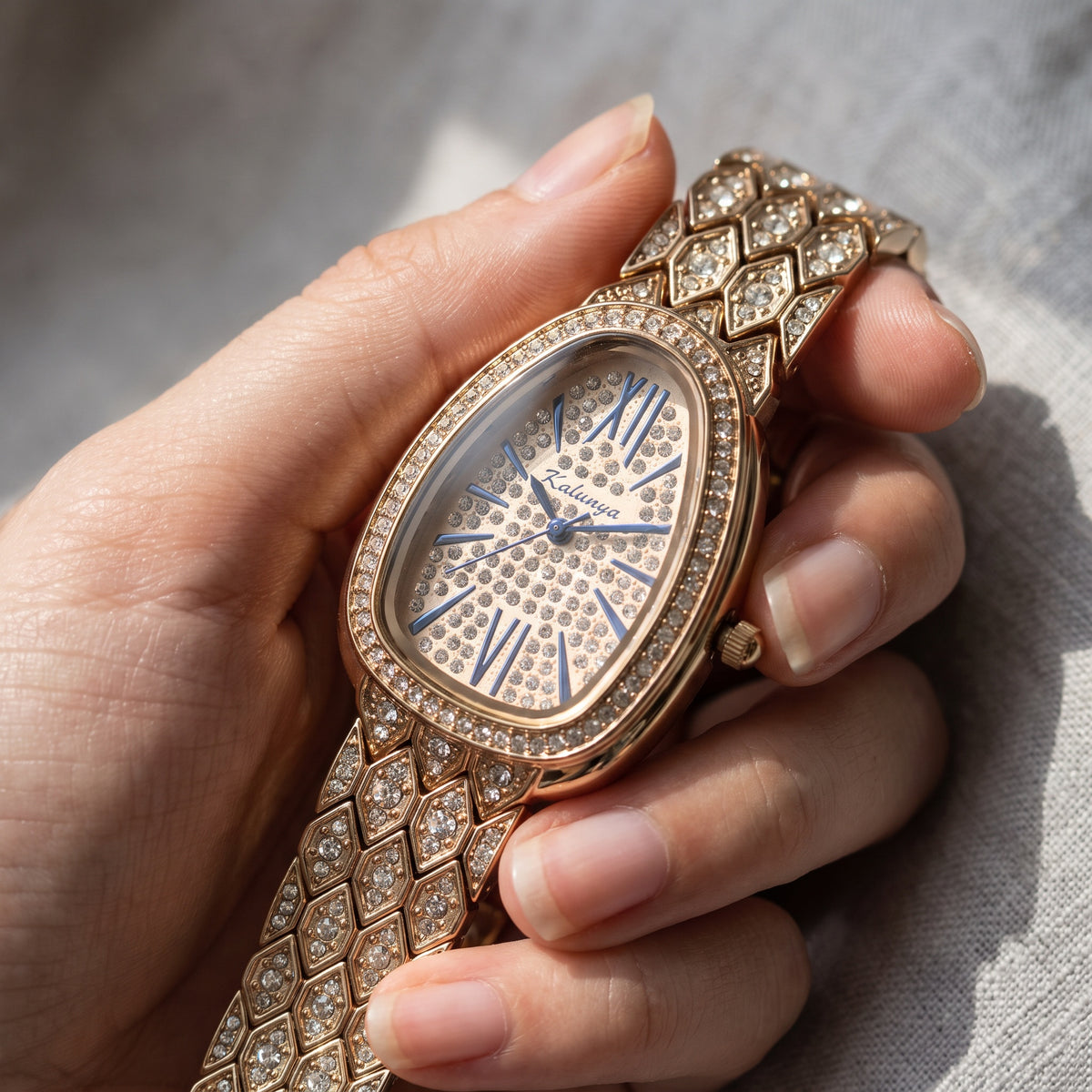 Empress Watch Golden: crystal-paved dial with blue Roman numerals, close-up