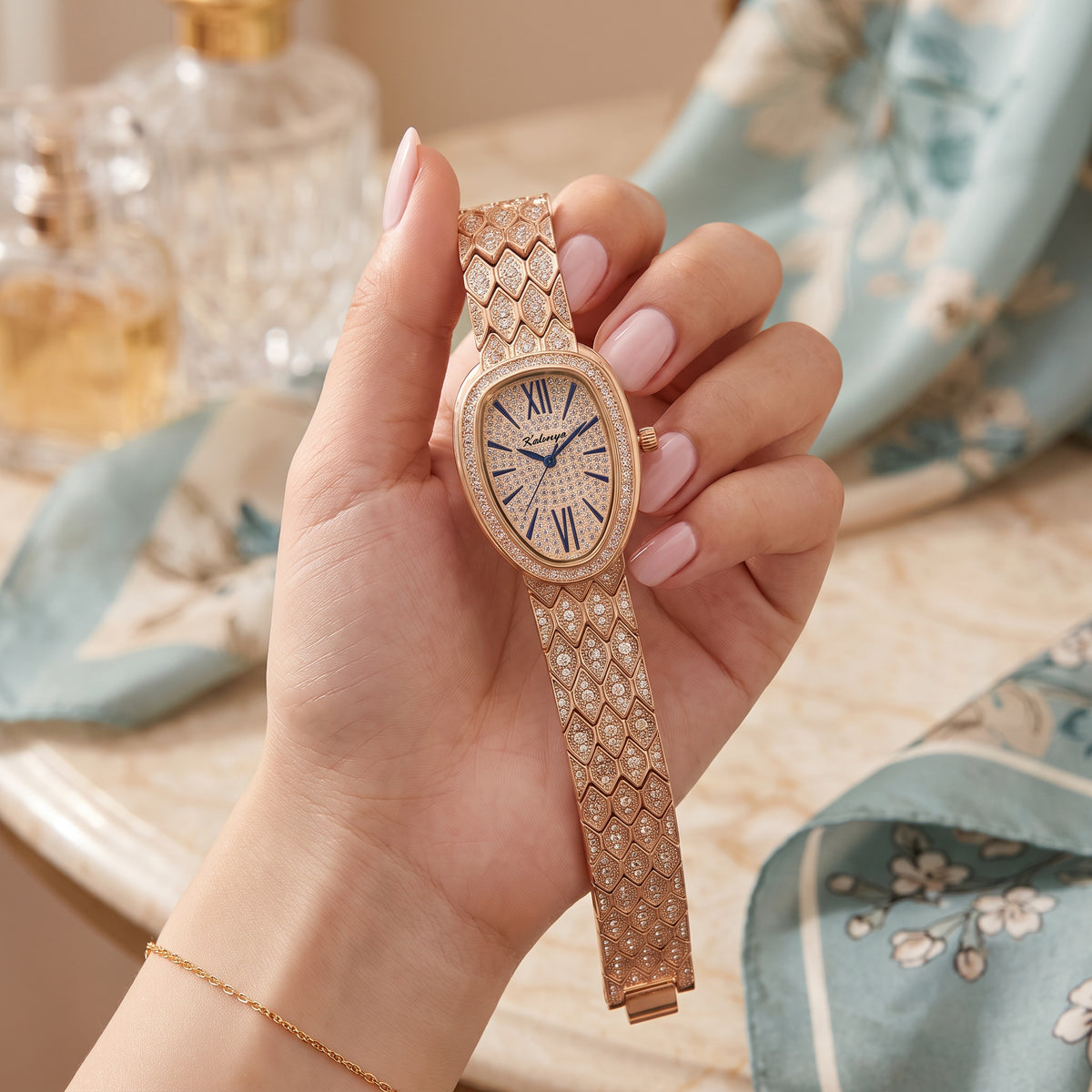 Empress Watch Golden held in hand on a vanity