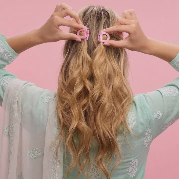 Two pink clip halves snapping flush into one clip, half-up style